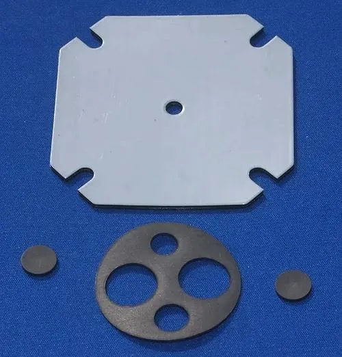 The original product photograph: a metal pump plate and three rubber gaskets laid on a bright blue cloth background, unevenly lit and shot at an angle.